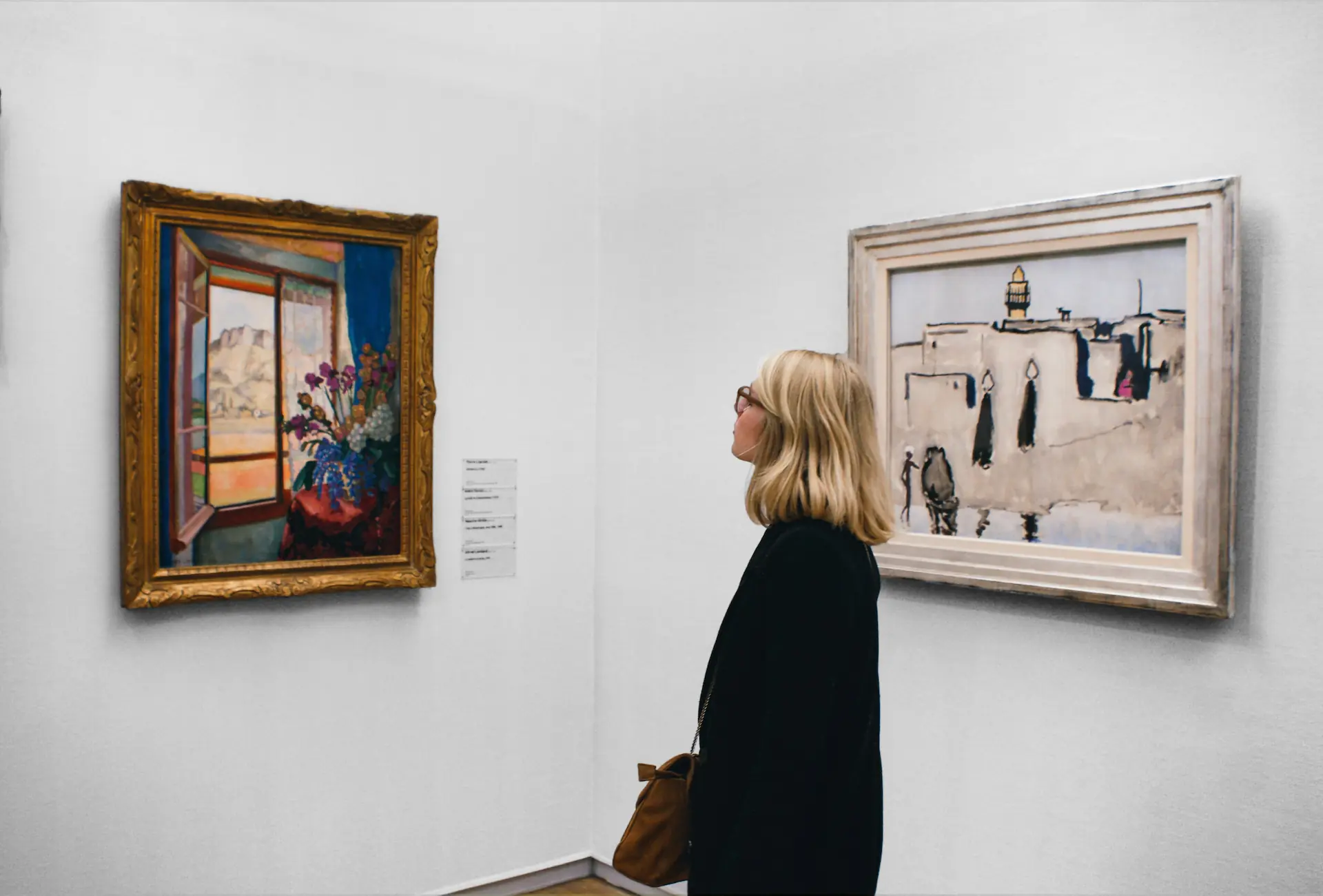 Imagen de una mujer en un museo observando un cuadro sobre flores